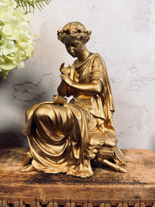 Spelter figural clock topper with laurel crown, sheet music & tambourine