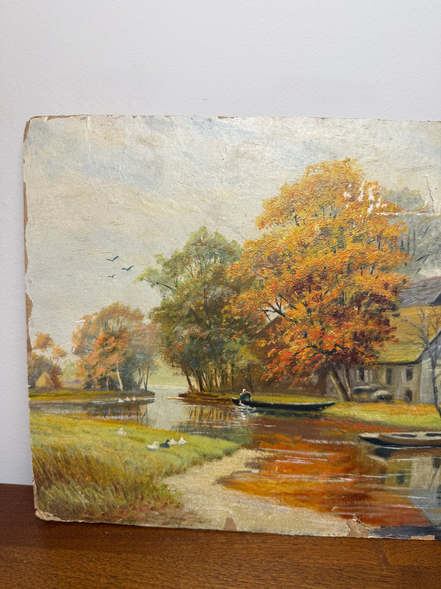 Autumn river landscape with boats and farmhouse, signed A. Renauld 194*