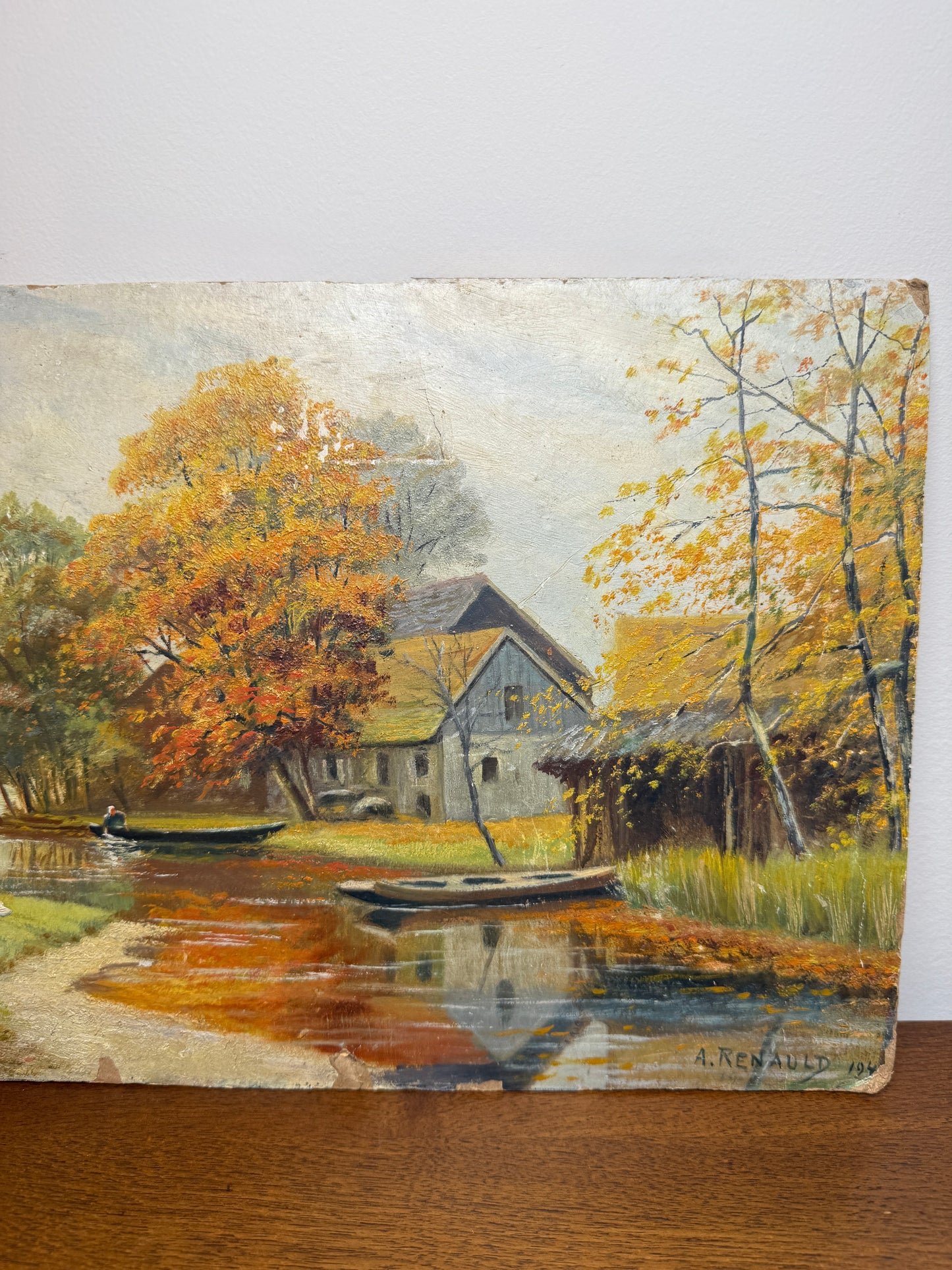 Autumn river landscape with boats and farmhouse, signed A. Renauld 194*