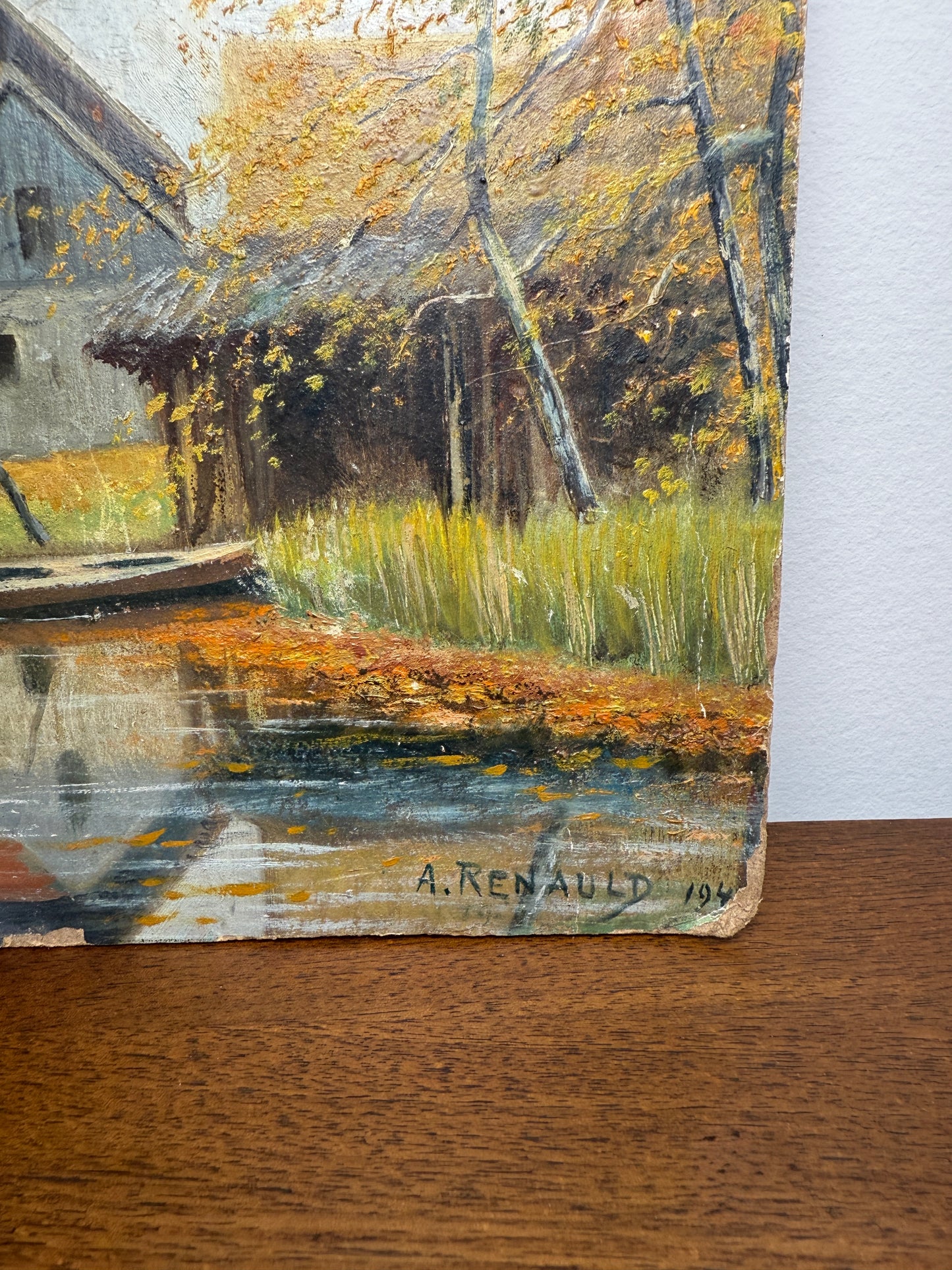 Autumn river landscape with boats and farmhouse, signed A. Renauld 194*