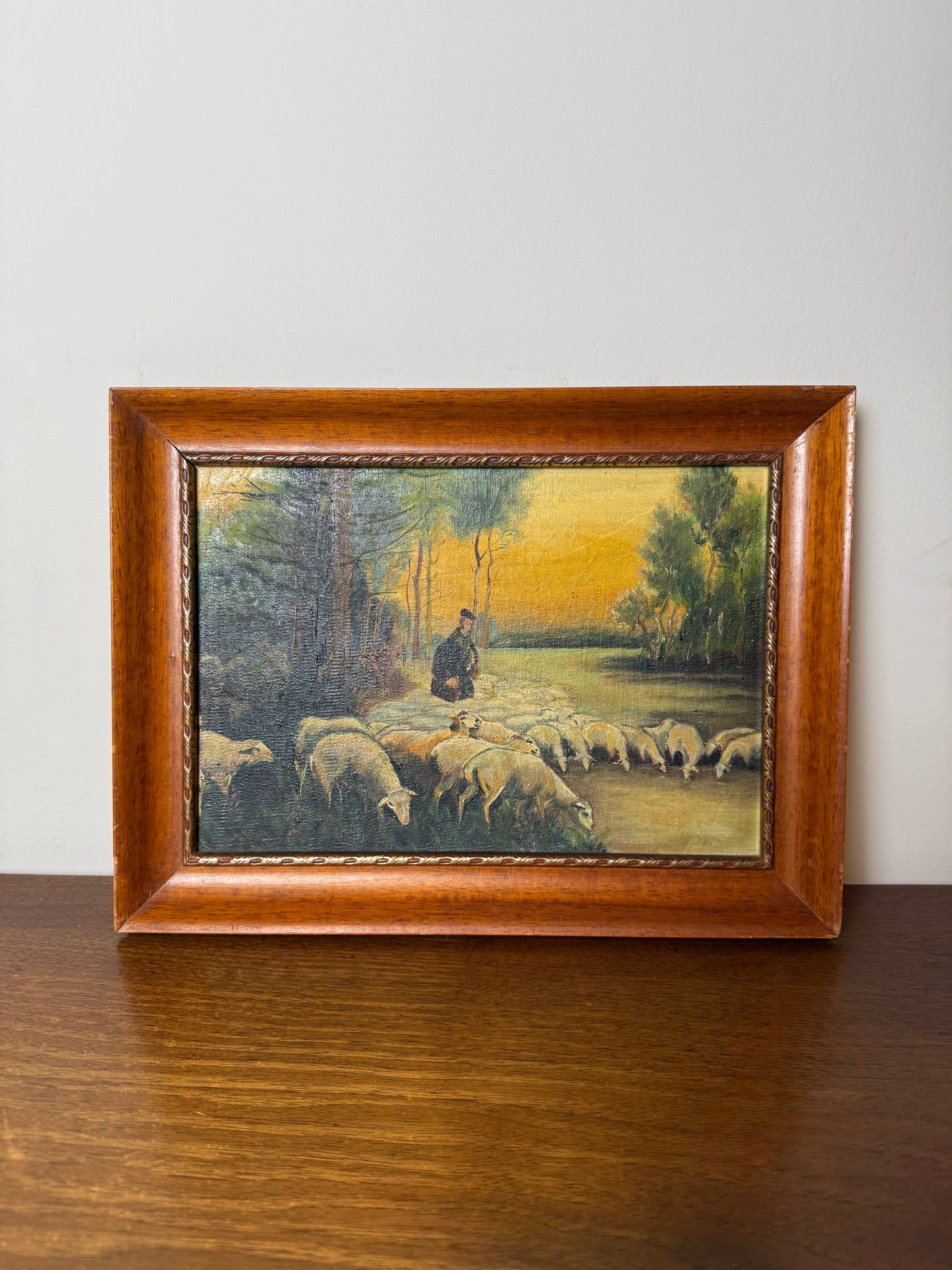 Shepherd with flock in pastoral landscape